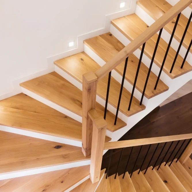 Wooden staircase with modern black railings.
